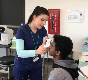 a nursing student examines a patient